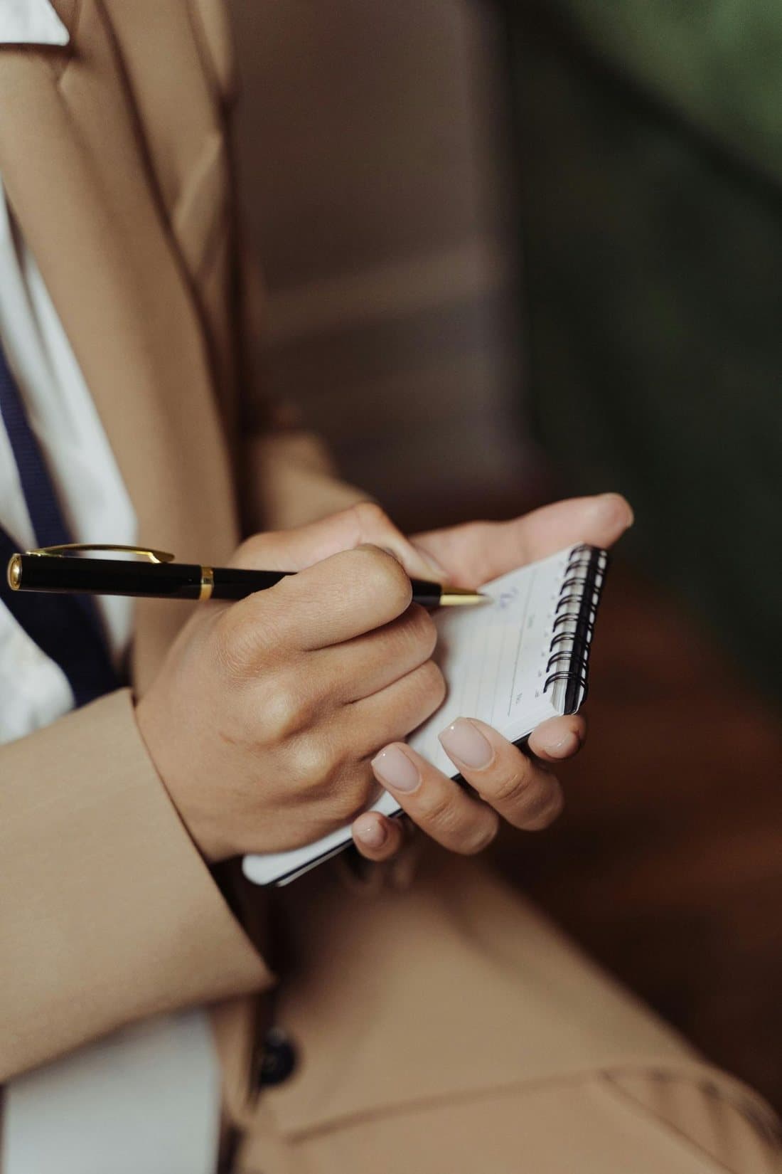 Close-up of hands taking notes during supervision