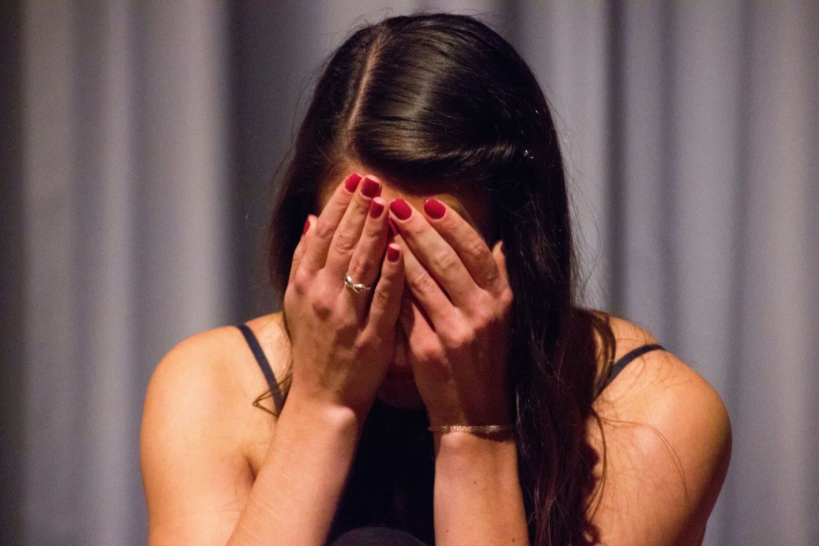 Woman with her head in her hands during a difficult moment